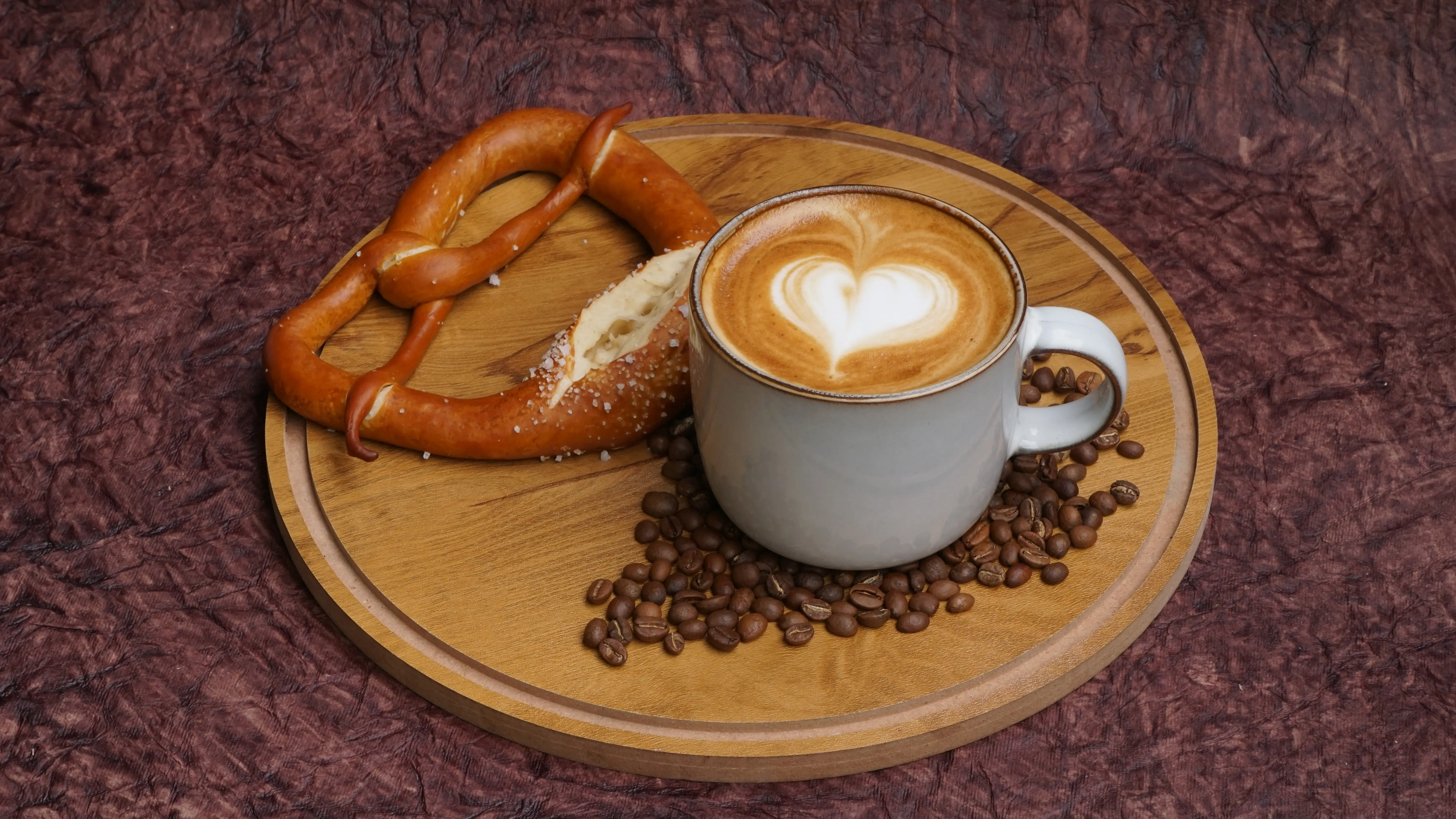 Pretzel sandwich trio on a wooden board